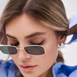 Modern rectangular metal sunglasses with gold frames and dark grey lenses on model
