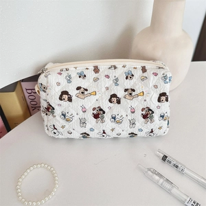 Close-up of quilted fabric stationery bag with cute cartoon dog prints and zipper closure