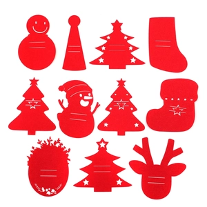 Flat lay of red felt Christmas table decorations including snowman, tree, and reindeer shapes