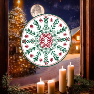 Close-up of a festive red and green snowflake mandala static window sticker on glass