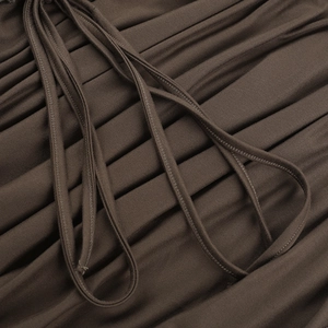 Close-up of coffee brown lace-up dress fabric showing knit texture and shoulder straps