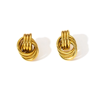 Detailed close-up of geometric layered gold knot earrings in a triple hoop design
