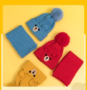 Detailed view of kids knitted hat and scarf sets in blue, red and yellow colors