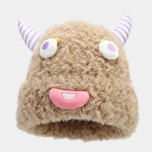 Detail of winter plush monster hat featuring purple striped horns and cute cartoon face