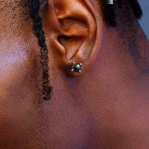 Hip hop black square zircon stud earring for men with faceted design on male model ear