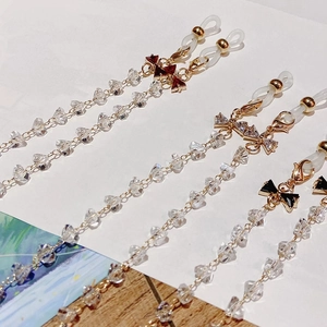 Detail of crystal eyeglass chains with colorful bow charms and gold lobster clasps