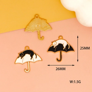 Detail view of cat and umbrella charms showing 25mm dimensions and metal texture