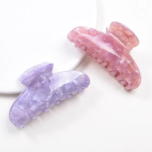 Pink and purple marble textured resin claw clips set displayed on a white background
