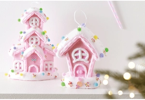 Pink gingerbread house ornaments with white cream and colorful candy balls for Christmas