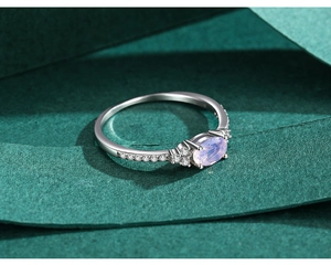 Macro shot of S925 silver ring featuring an oval pink zircon and small white diamonds