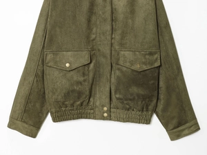 Detail of olive green suede jacket featuring cargo pockets and metallic snap buttons