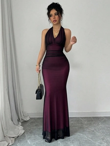 Detail of V-neck mesh overlay and ruched fabric on a purple fishtail evening dress