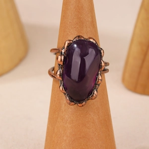 Detailed view of raw purple amethyst stone set on a vintage bronze adjustable punk ring