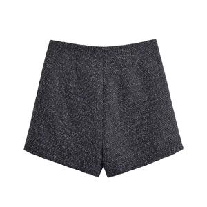 Detail view of the black and grey tweed fabric texture on fashion mini shorts