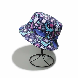 Close-up of deep blue sun hat with detailed whale and sea life cartoon prints