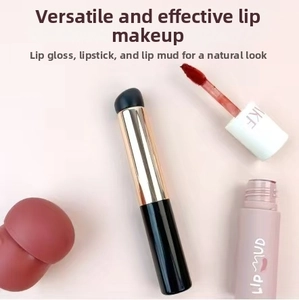 Detail of round head silicone lip brush with golden ferrule for blending and concealer
