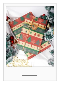 Close-up of brown kraft Christmas gift wrap with reindeer patterns and cedar decoration