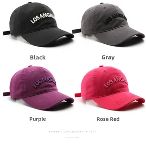 Detail view of embroidered Los Angeles baseball caps in black, grey, purple and rose