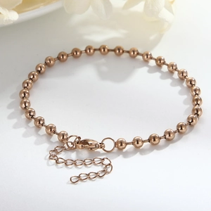 Detailed shot of rose gold beaded bracelet with lobster clasp and extension chain