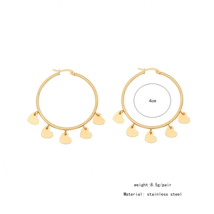 Detailed view of gold stainless steel hoop earrings with five hanging heart charms