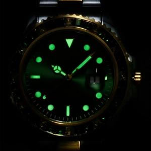 Detailed macro view of the luminous green dial and date window on this waterproof watch