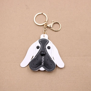 Close-up of beagle dog leather keychain with gold lobster clasp on cardboard backing