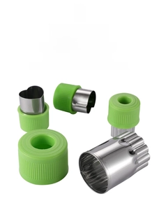 Detail of 12-piece stainless steel vegetable cutters with green ergonomic handles