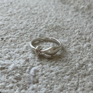 Minimalist 925 sterling silver rope knot ring shown on a textured stone background