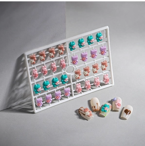 Close-up of 25 resin cartoon animal nail charms including rabbits and bears for 3D nail art