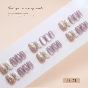 Cat eye press-on nails with floral designs and glitter in purple and champagne tones