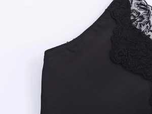Detailed view of the intricate black lace neckline and silky satin fabric texture