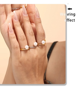 Close-up of titanium steel nail rings with pearls and zircon on model hand