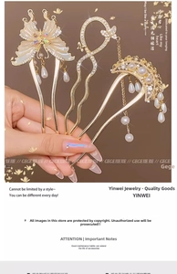Detail of three-piece golden hairpins with pearls, butterfly design and crystals