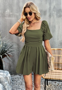 Detail of olive green puff sleeve romper with square neckline on professional model