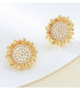 Detailed close-up of golden sunflower stud earrings with shimmering inlaid zircons