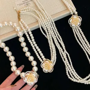 French vintage multi-layer pearl necklace featuring a diamond-set floral rose pendant