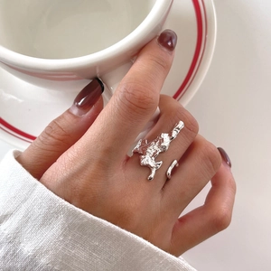 Close-up of irregular lava texture on 925 silver open ring shown on a model hand