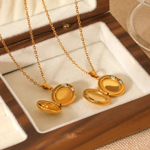 Star and moon locket necklace in gold stainless steel presented in a wooden gift box