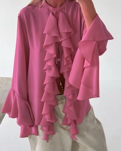 Detail of rose pink chiffon blouse featuring elegant layered ruffles on sleeves and front