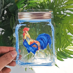 Close-up of holographic rooster suncatcher sticker with rainbow prism effect on window