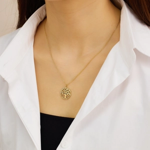Detail of gold tree of life pendant with love and life engraving on a snake chain