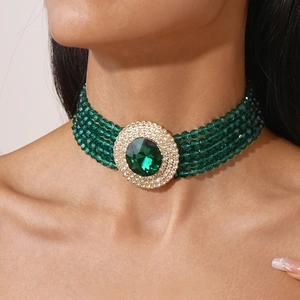 Detailed view of luxury multi-layer green beaded choker with large central rhinestone pendant