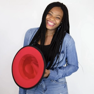 Detail view of stylish two-tone felt fedora hat featuring black exterior and red interior