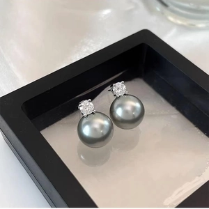 Elegant grey pearl stud earrings with zircon inlay in a minimalist jewelry box