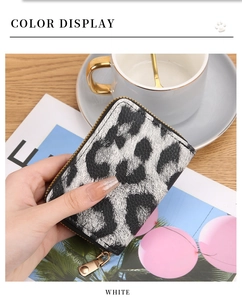 Detailed view of leopard print card holder with gold zipper and pebble leather texture
