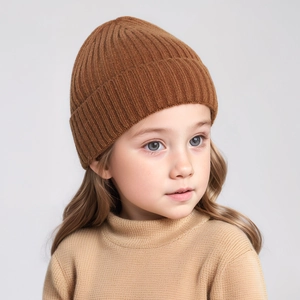 Detailed knit texture of the caramel brown infant beanie with classic ribbed pattern