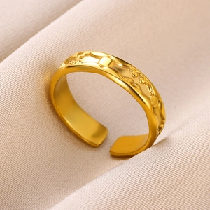 Detail of 18k gold plated stainless steel ring with embossed cloud patterns on silk
