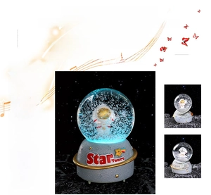 Detail of luminous astronaut snow globe music box with Star Tours embossed resin base