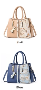 Close-up of khaki and blue handbags featuring floral print and bow charm detail