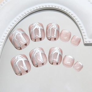 Pink cat eye press-on toenails with liquid silver metallic textures on a mirror base